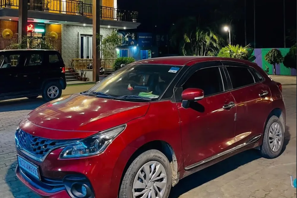 Real MD Cabs Maruti Suzuki Baleno stopped for the evening during an outstation trip in Assam