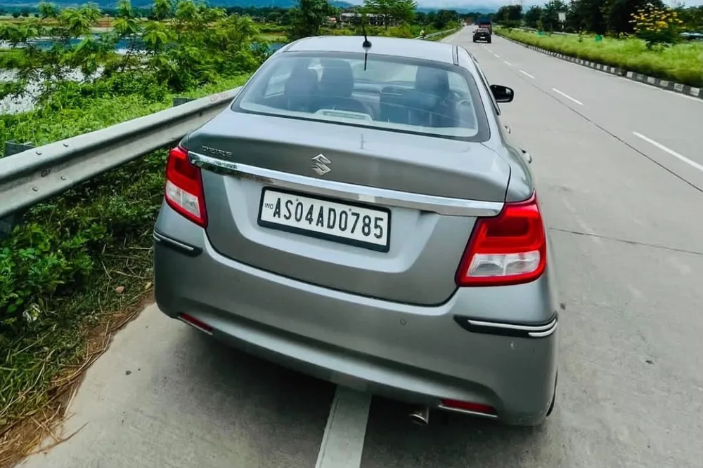 Real MD Cabs Maruti Suzuki Dzire sedan on the highway near Jorhat