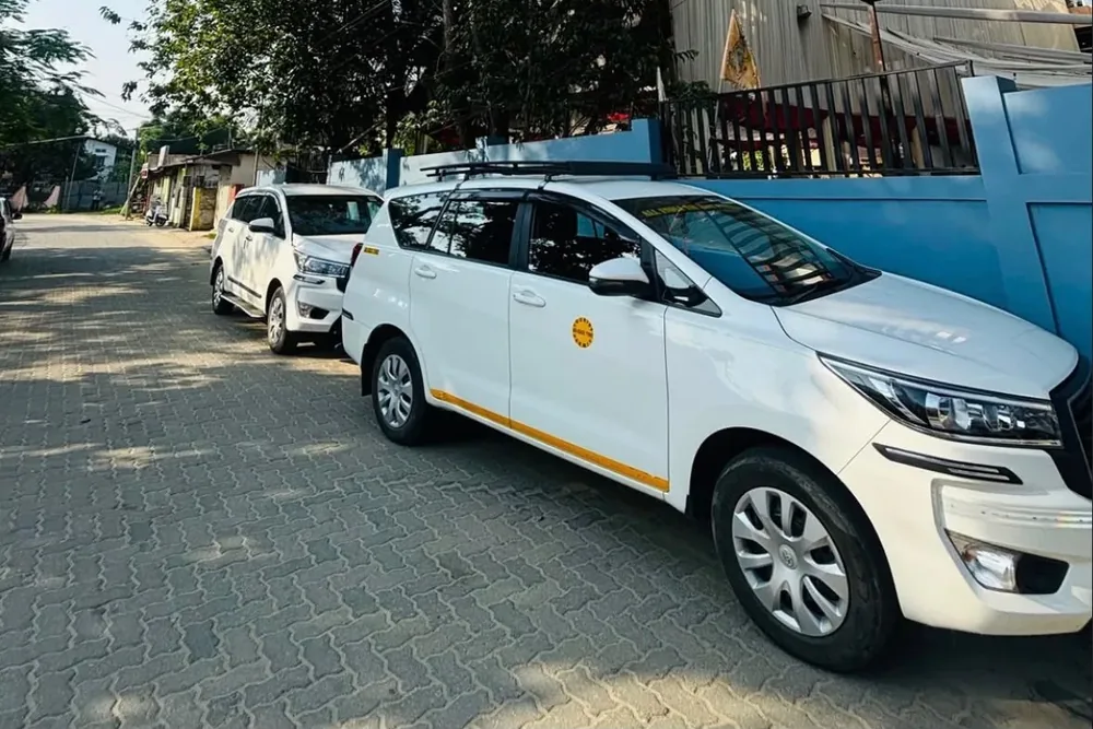 Real MD Cabs Toyota Innova SUVs parked outside our Jorhat office, part of our taxi fleet